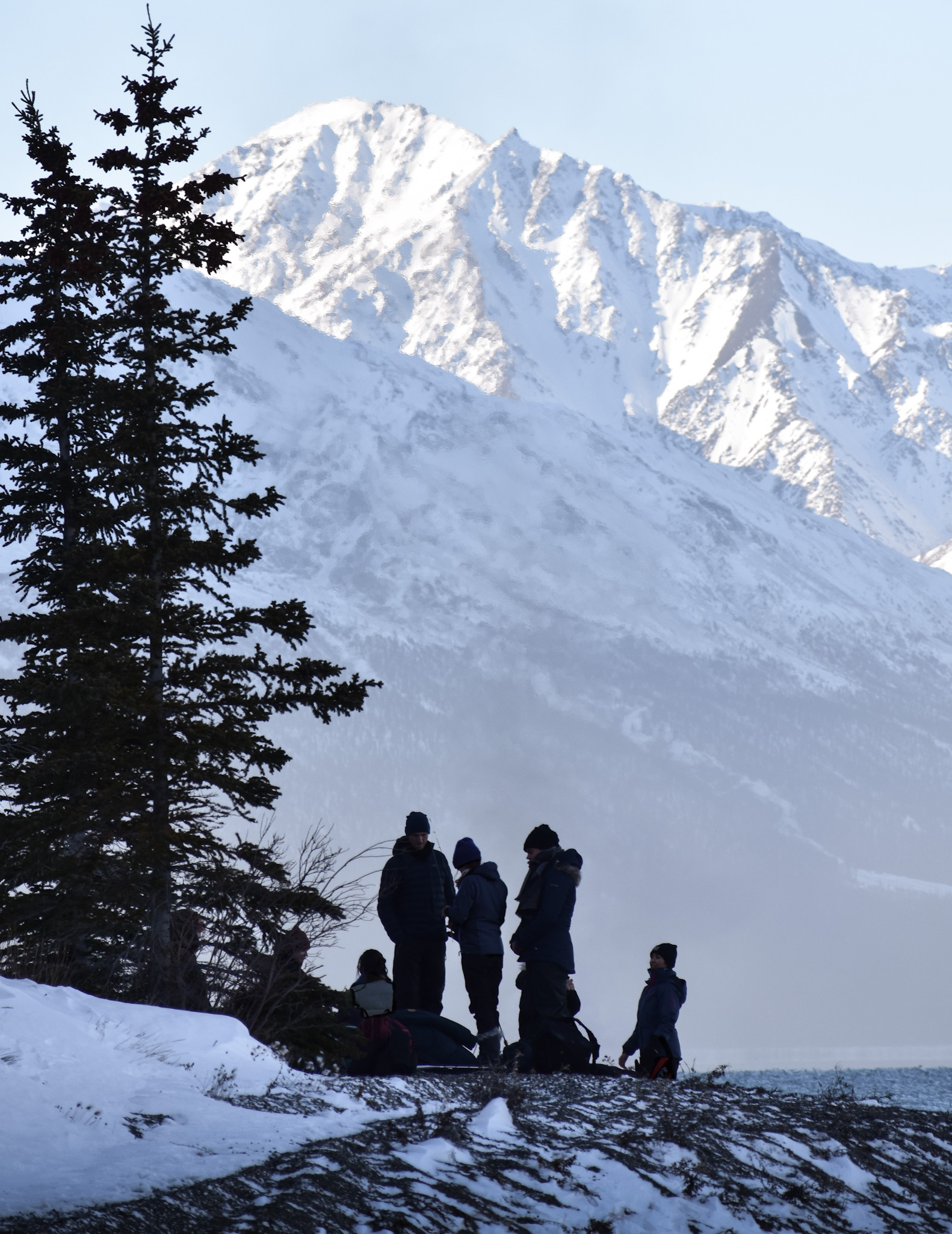 People silhouetted in front of mountain