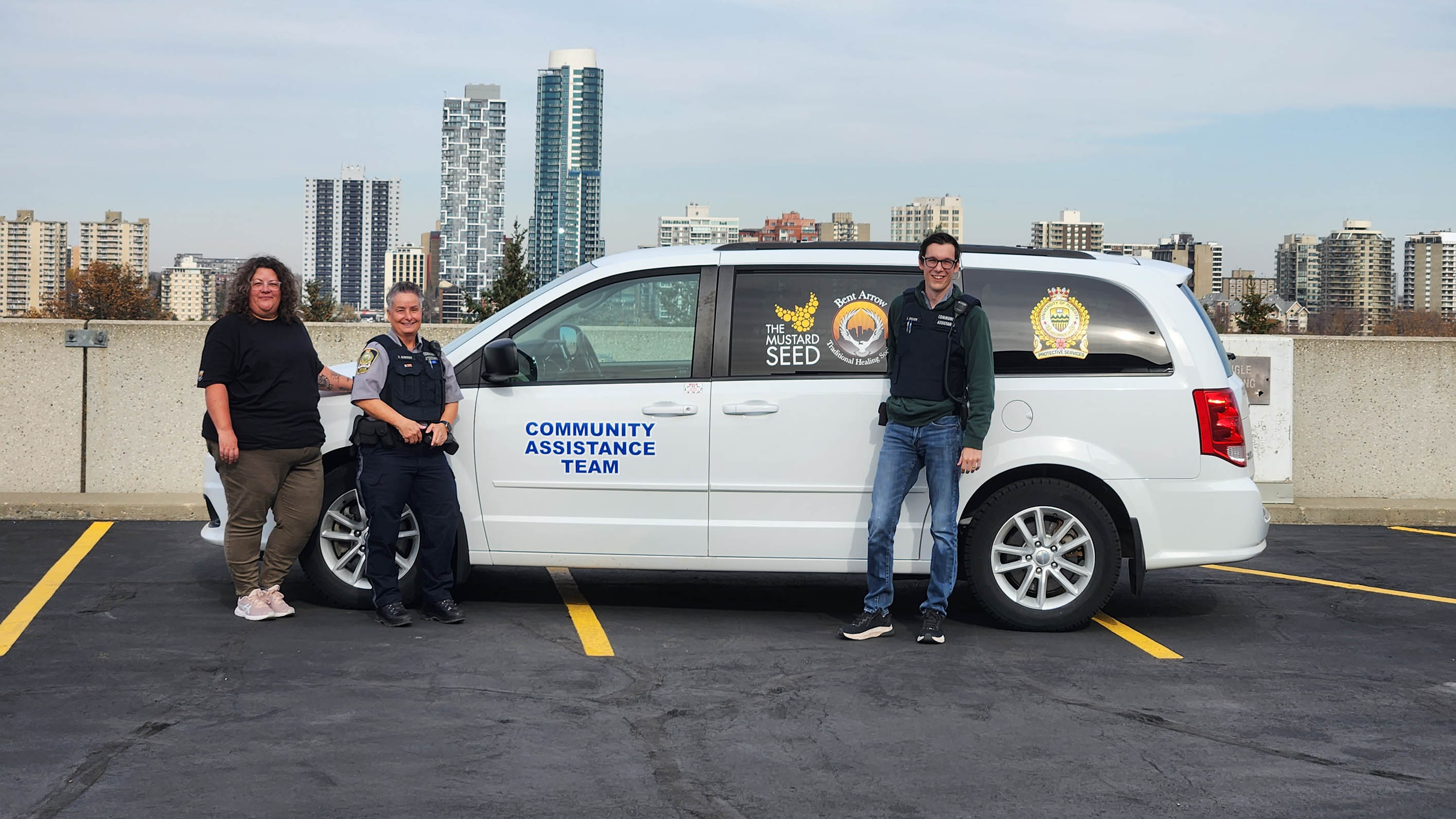 Three people in front of van