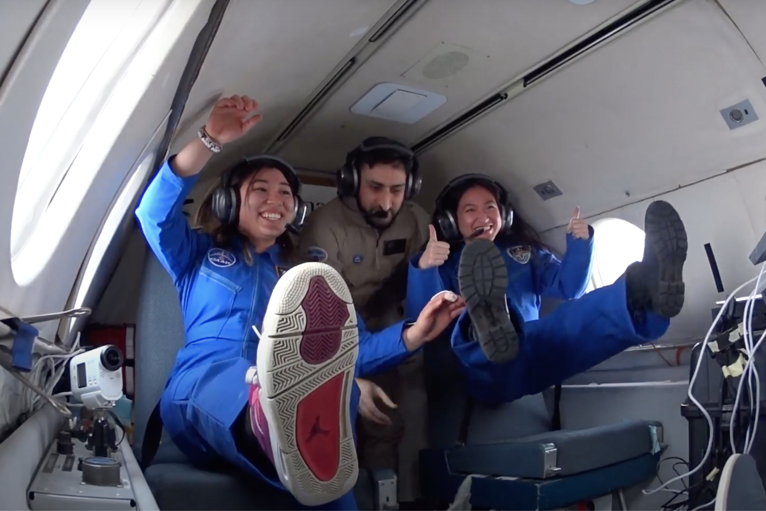 Mission Spacewalker Mission Specialists and Shahrukh (middle) from the NRC in microgravity