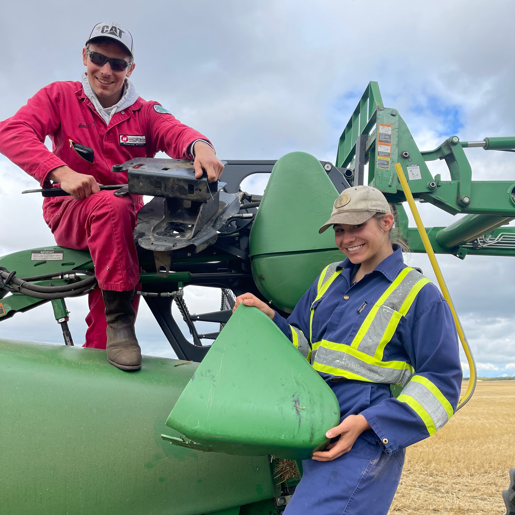 Alyson and her brother Wyatt fixing a combine header.