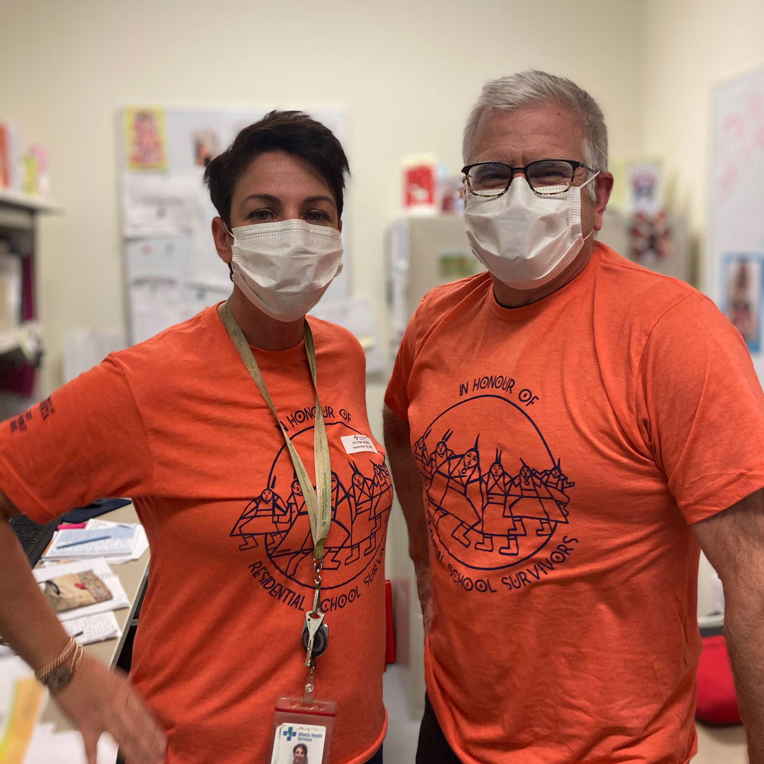 Janice Dominguez and Dr. Blaine AuCoin in orange shirts