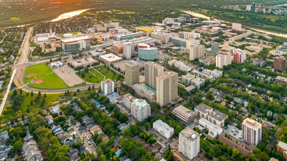 An aerial shot of the University of Alberta area in Edmonton's River Valley with campus buildings, apartment and condo complexes, and various other types of residences.