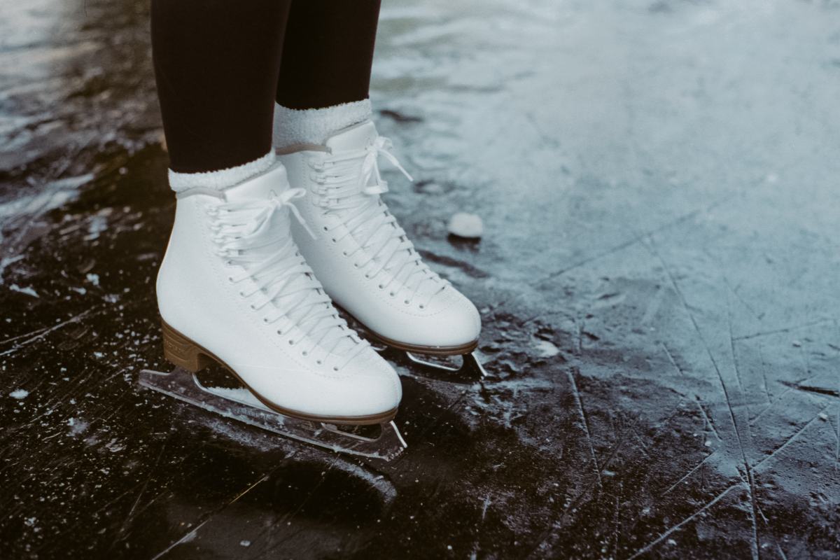 A person wearing ice skates standing on ice.